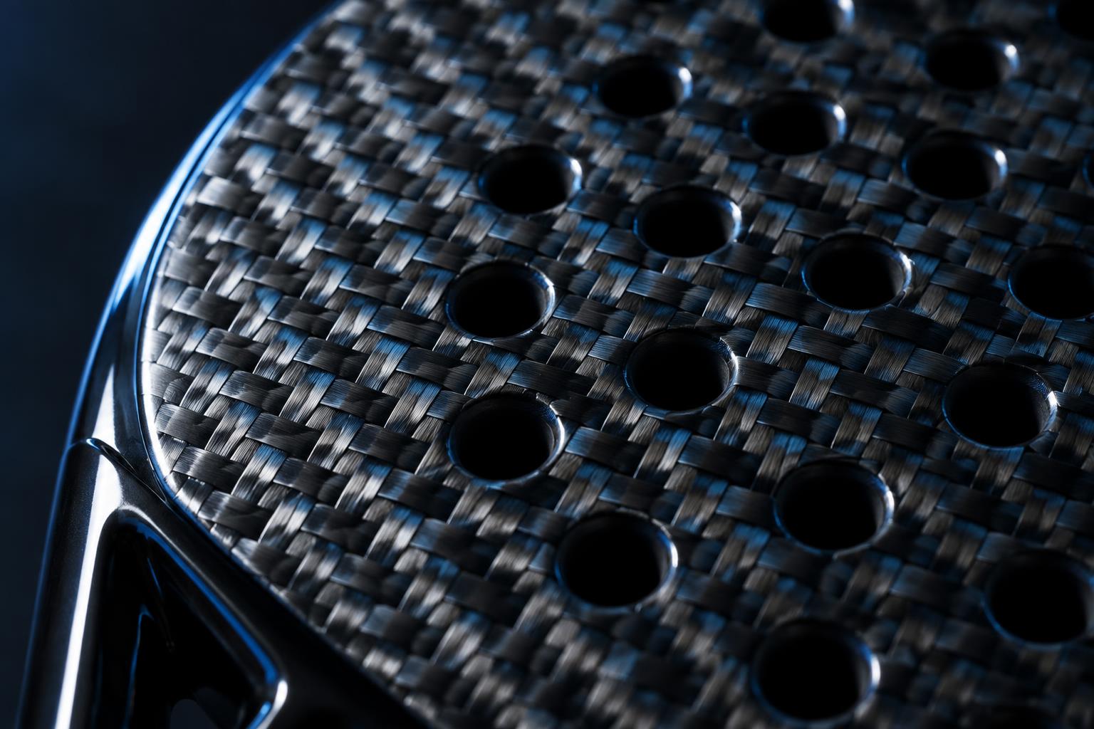 Macro detail of the 18K carbon fibre weave on the racket face